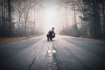 Man on road in foggy weather