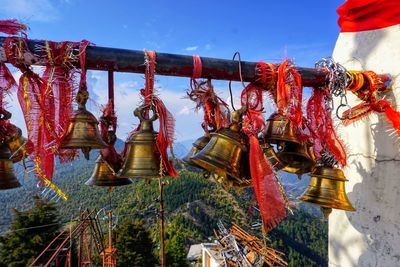 Clothes hanging on rope against sky