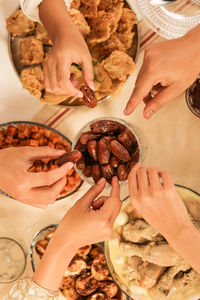 Hands take dates fruit or kurma, concept buka bersama, sharing food during ramadan fasting month