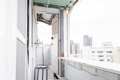 Buildings against clear sky seen from balcony