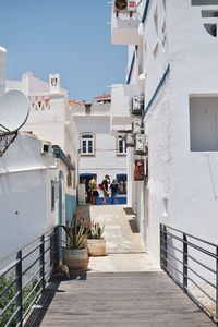 People walking on steps against clear sky