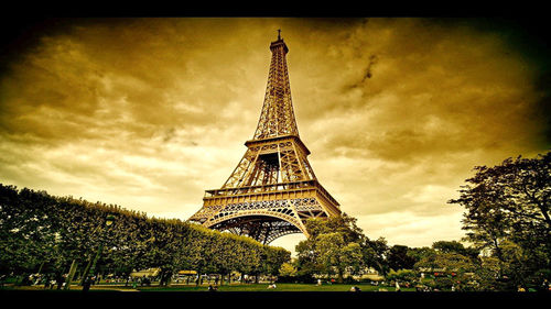 Low angle view of tower against cloudy sky