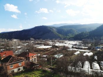 High angle view of houses and mountains against sky