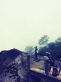 Man standing on mountain against clear sky