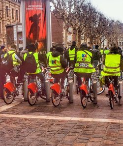 People riding bicycles on street in city