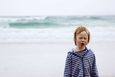 Boy standing on beach