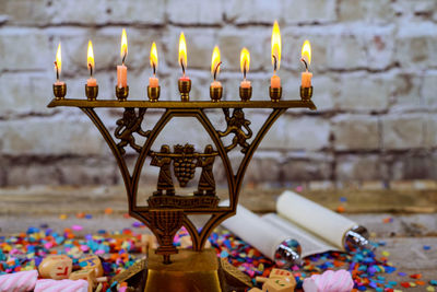 Illuminated lamps on temple against building