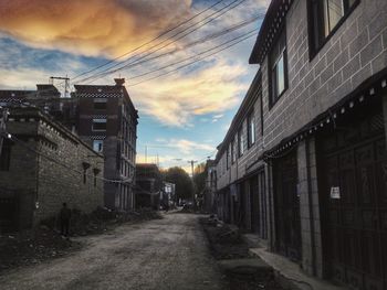 Street amidst buildings in city against sky