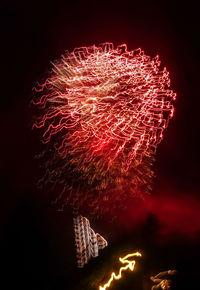 Low angle view of firework display at night