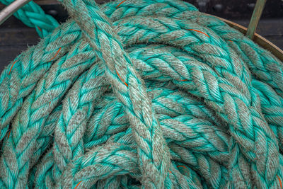 Directly above shot of turquoise rope rolled on boat