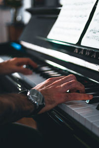 Midsection of person playing piano