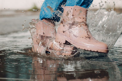 Low section of person splashing water