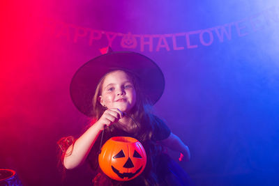 Portrait of girl against illuminated light