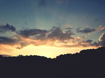 Silhouette of landscape against sky at sunset