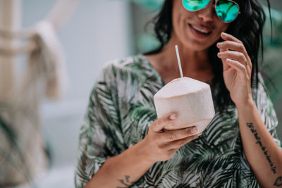 Midsection of woman holding ice cream