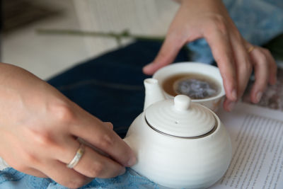 Midsection of woman serving tea