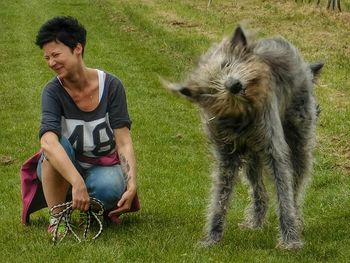 Full length of man with dog on grass