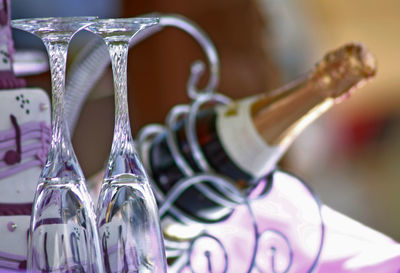 Close up of wine bottle with glasses on table