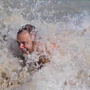 Portrait of man splashing water