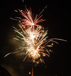 Low angle view of firework display at night