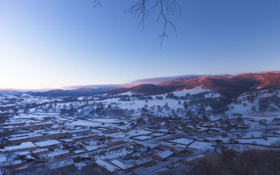 Aerial view of townscape against sky during winter