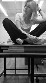 Young woman sitting on table