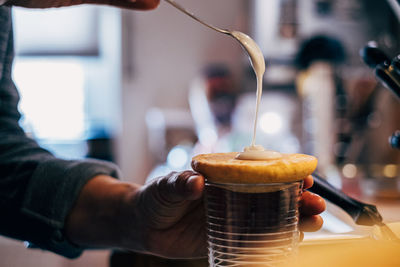 Hand prepairing small cake with sugar icing