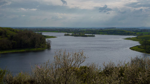 Scenic view of lake against cloudy sky