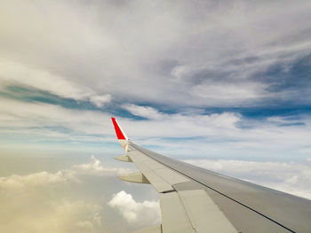 Low angle view of airplane flying against sky