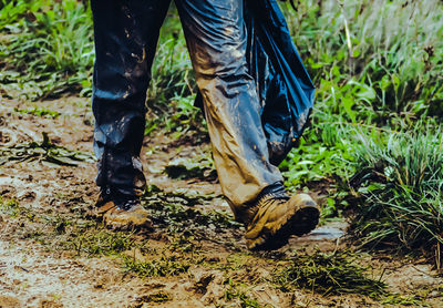 Low section of man standing on field