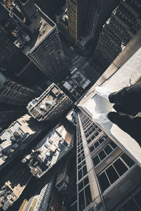 Low section of person standing on building in city