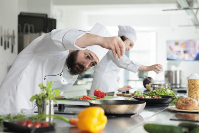 Midsection of woman preparing food at home