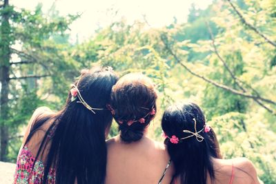 Rear view of women in park against sky