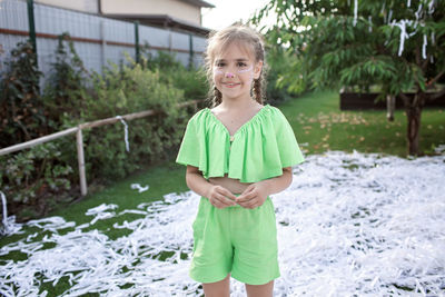 Portrait of smiling girl standing outdoors