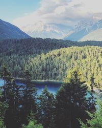 Scenic view of lake and mountains against sky