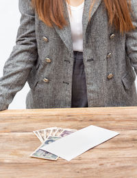 Close-up of woman with umbrella on table