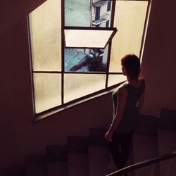 Woman looking through staircase window