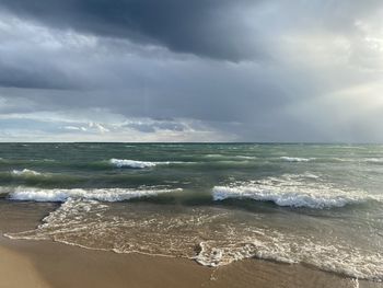 Scenic view of sea and waves against sky