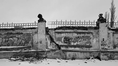 Man on wall against clear sky