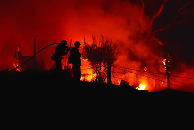 Silhuette of firefighter against red sky