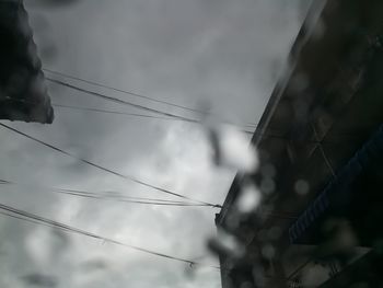 Low angle view of cables against sky