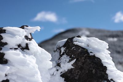 Close-up of snow against sky