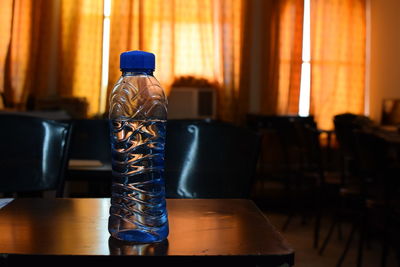 Close-up of water bottles on table