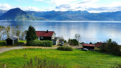 Scenic view of river and mountains in front of house