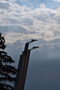 Low angle view of crane against sky