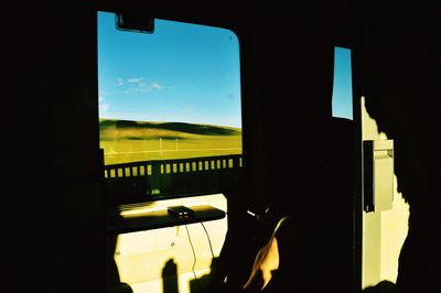 Silhouette trees seen through train window