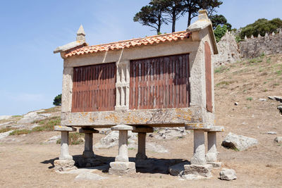 Old building on field against sky