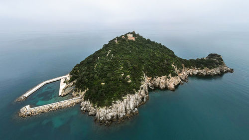 High angle view of island amidst sea against sky