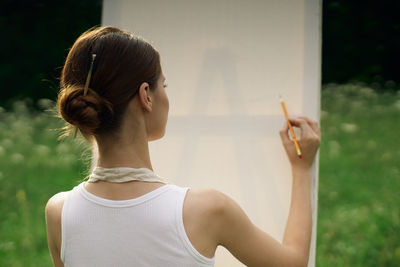 Midsection of woman holding camera