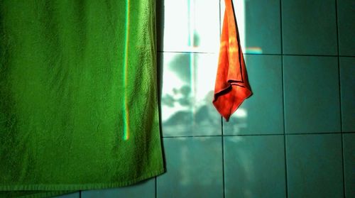 Close-up of towel against tiled wall